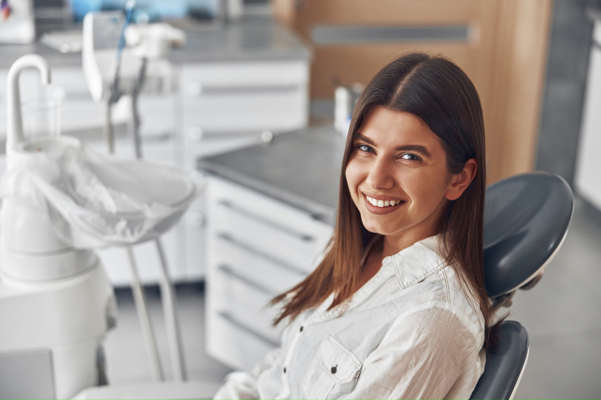 Happy caucasian woman at dentist cabinet