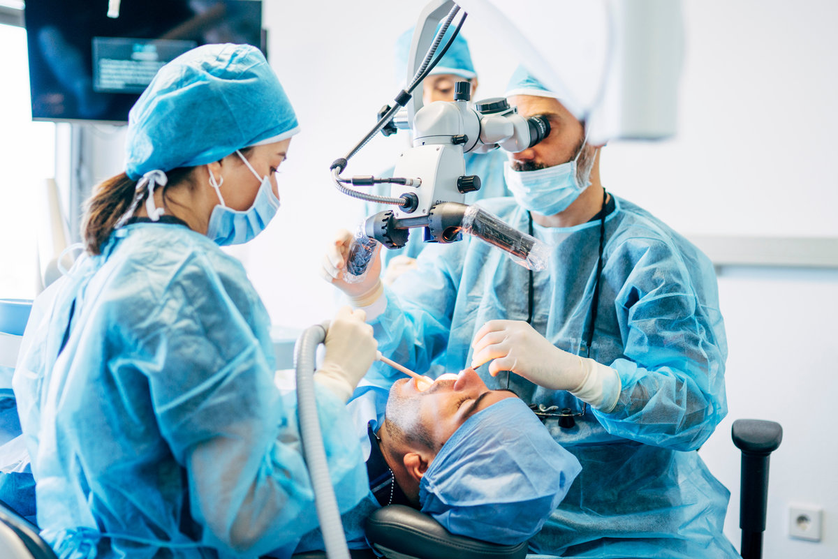 Team dental surgeons working in dental clinic.