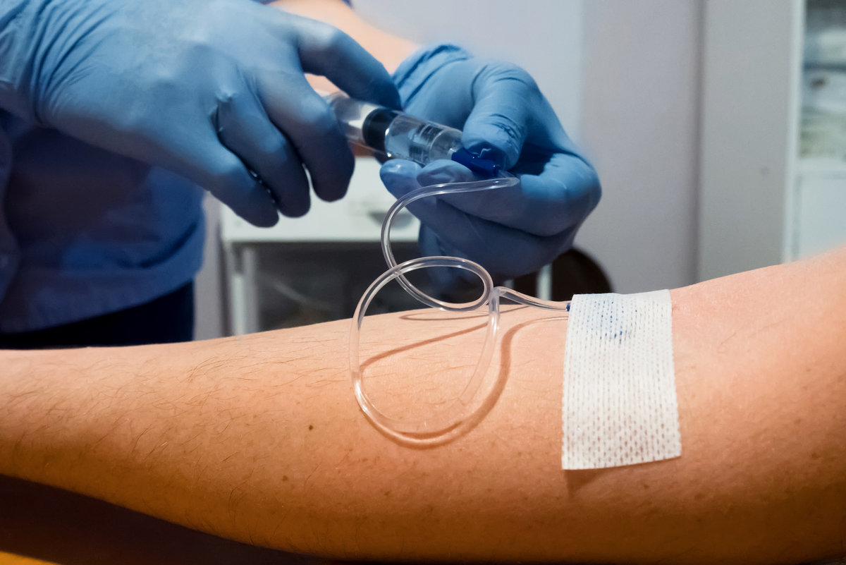 Intravenous injection. The introduction of the drug into the patient’s hand.