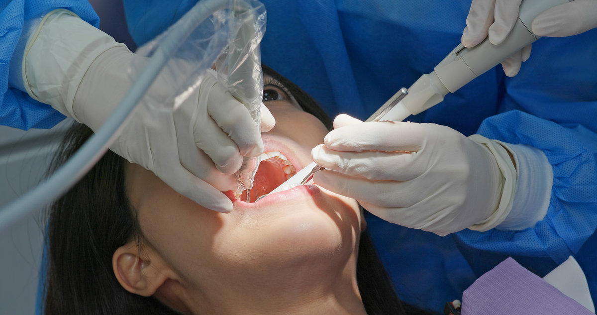 Woman undergo dental scaling treatment