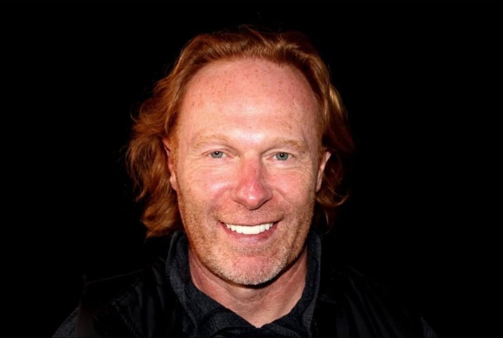 Man with reddish hair smiling after dental treatment at Evergreen Grace Dental Care