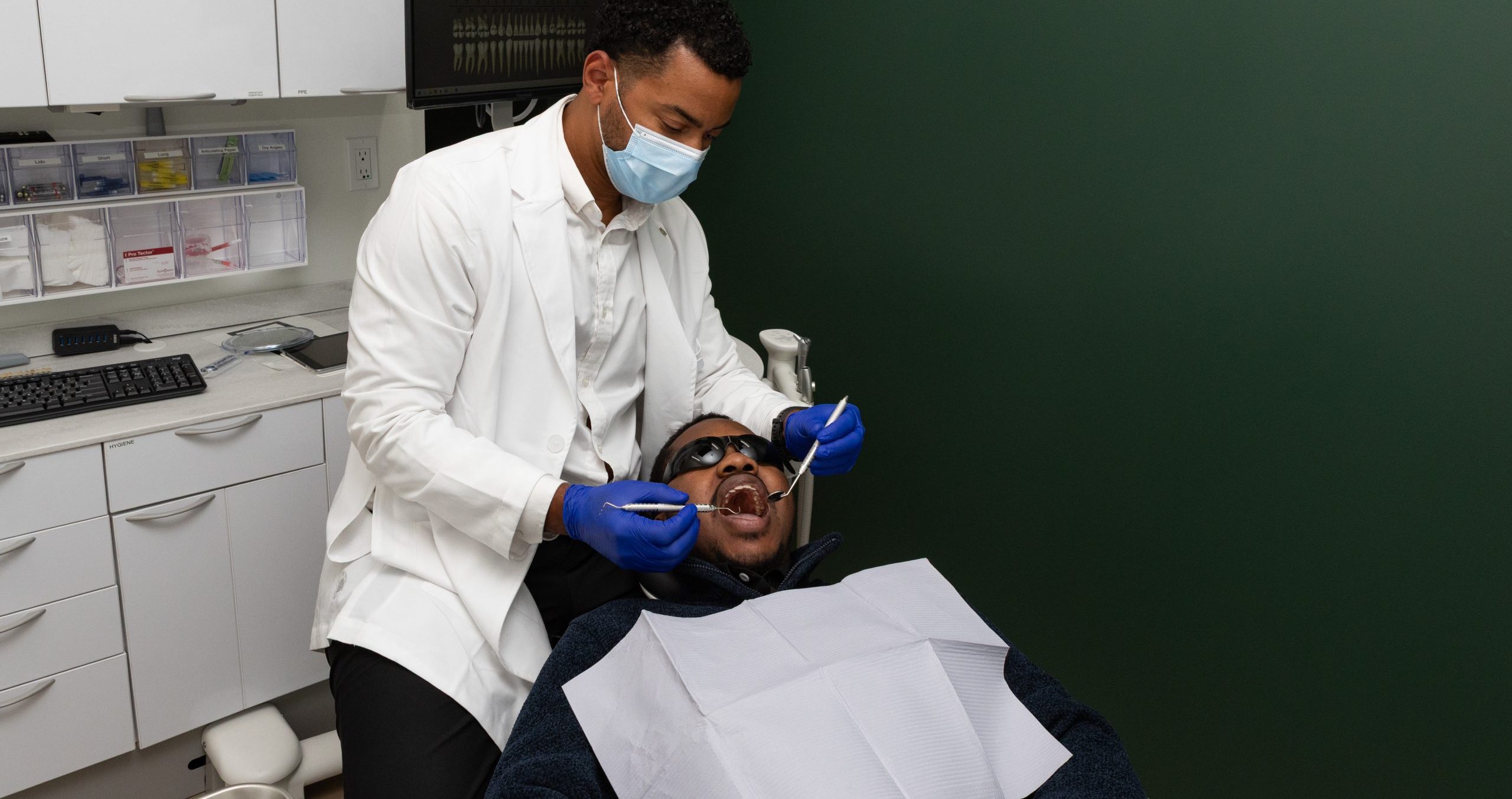 Dentist performing oral examination with intraoral camera at Evergreen Grace Dental Care
