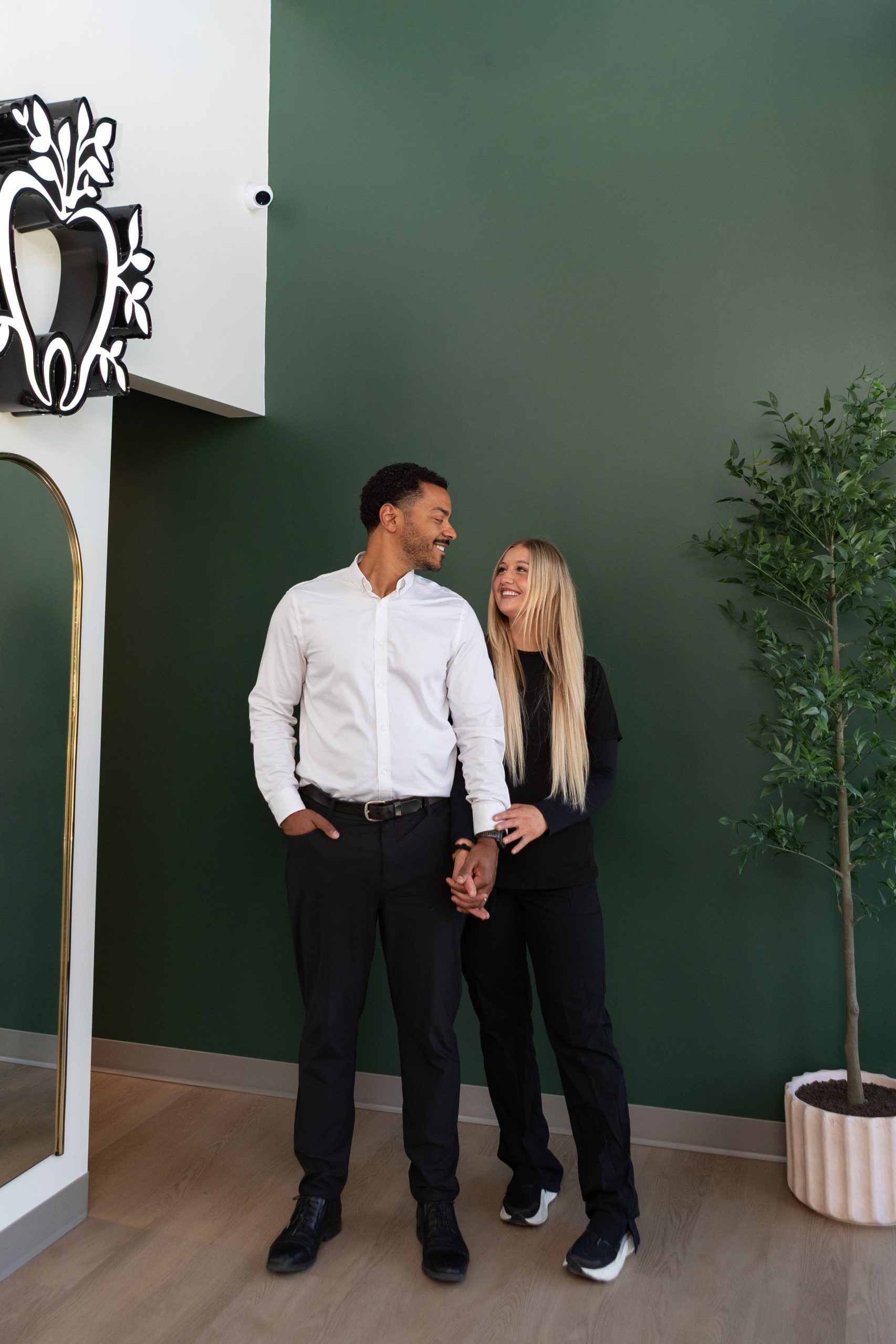 Evergreen Grace Dental Care team members in office lobby with branded signage
