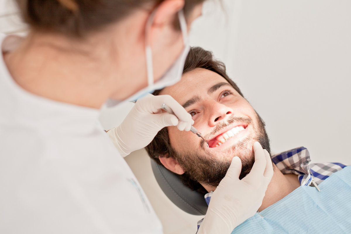 young man and woman in a dental examination at dentist