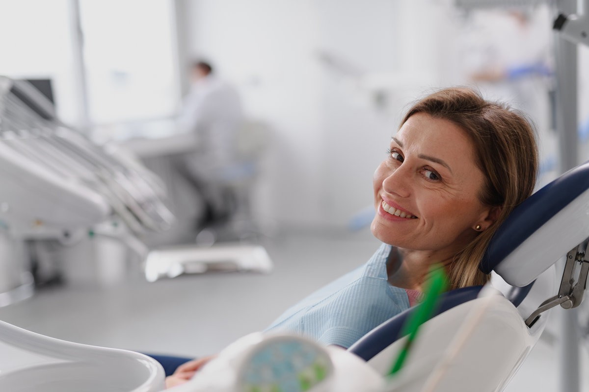 A woman in dentist chair during her annual ceck up in dental clinic.